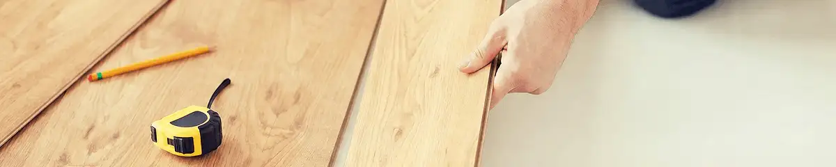 A professional installing wood flooring in Worcester, MA