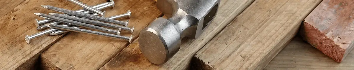 Hammer and nails on hardwood flooring boards in Worcester, MA