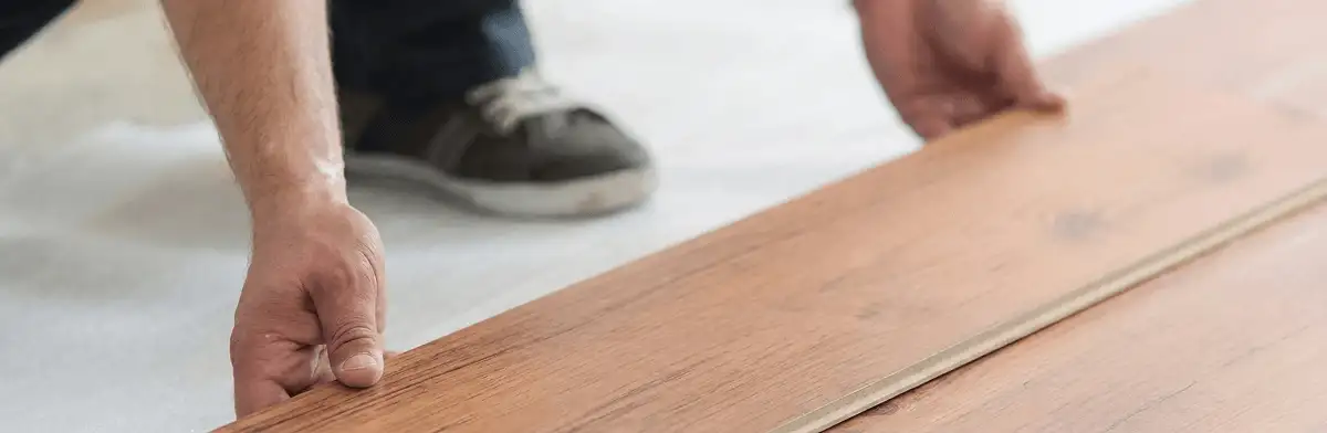 A professional installing laminate flooring in Worcester, MA