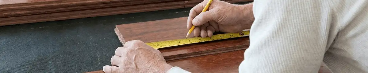 A professional installing wood flooring in Worcester, MA